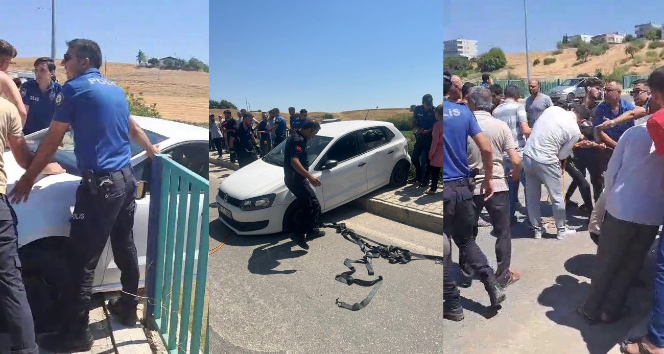 Köprüde asılı kalan otomobil düşmesin diye üzerine çıktılar