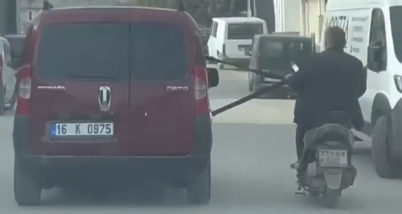 Emniyet kemerine tutunarak motosiklet çektiler