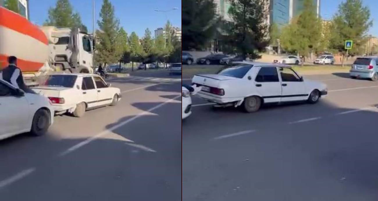 Yolda kalan Fiat Tofaş’ı, başka bir aracın kaputuna çıkıp ayakları ile ittirdiler