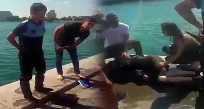 Kahraman zabıta sıcaktan bayılıp denize düşen kadını kurtardı