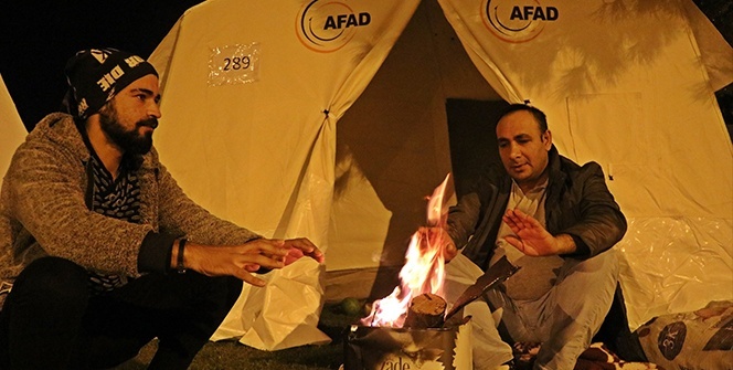 Çadırlarda kalan depremzedeler, soğuk havada ateş yakarak ısınmaya çalışıyor