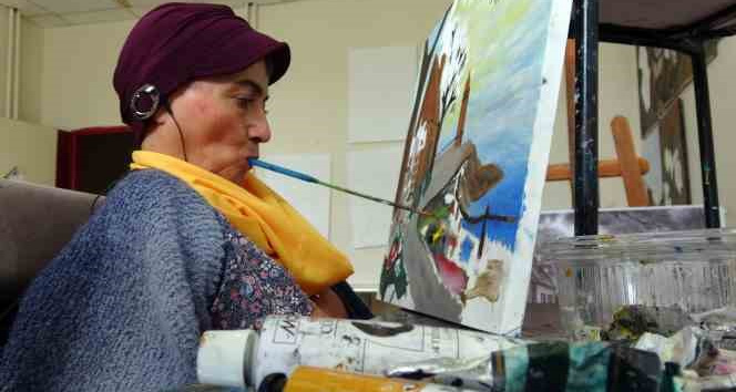 Engelli kadın ağzıyla depremzedeler için resim çiziyor