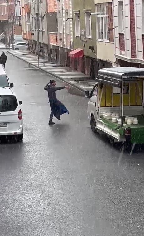 Yağan kara aldırış etmeyen seyyar satıcı sokak ortasında oynadı
