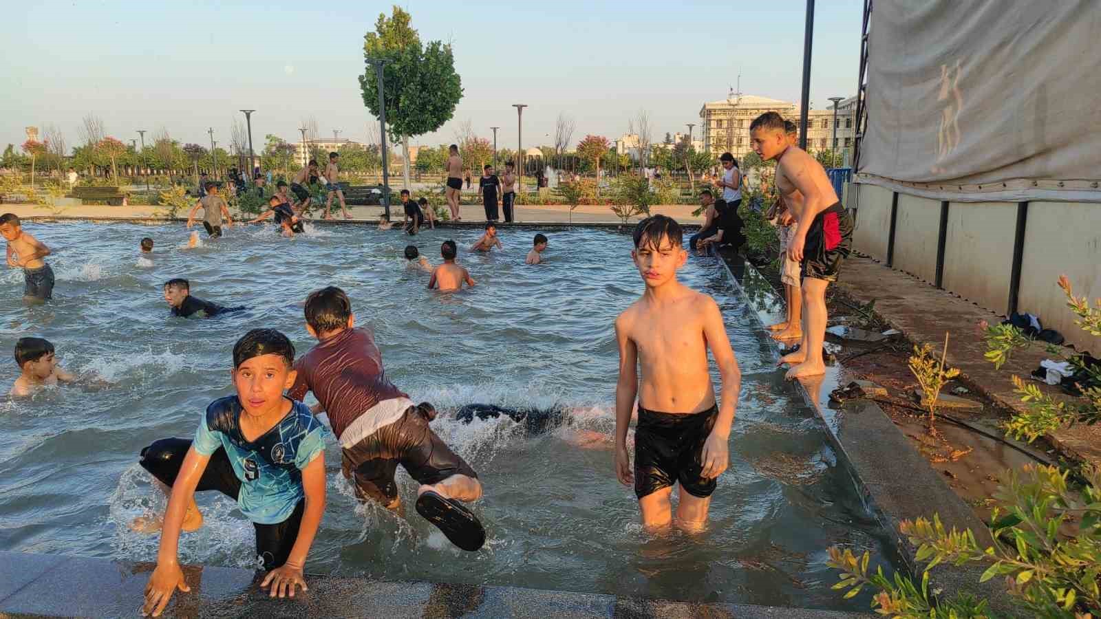 Şanlıurfa’da sıcaktan bunalan çocuklar süs havuzunda serinledi