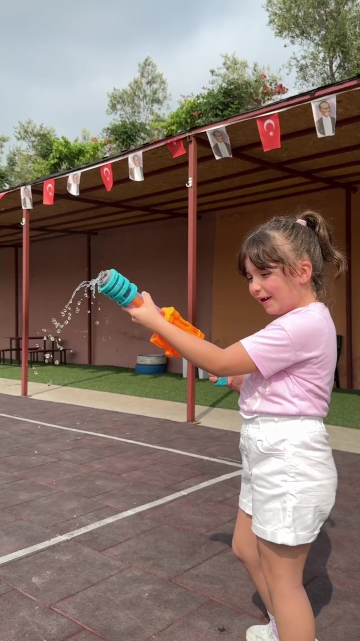 Sıcaktan bunalan öğrenciler su savaşıyla serinledi, ortaya renkli görüntüler çıktı
