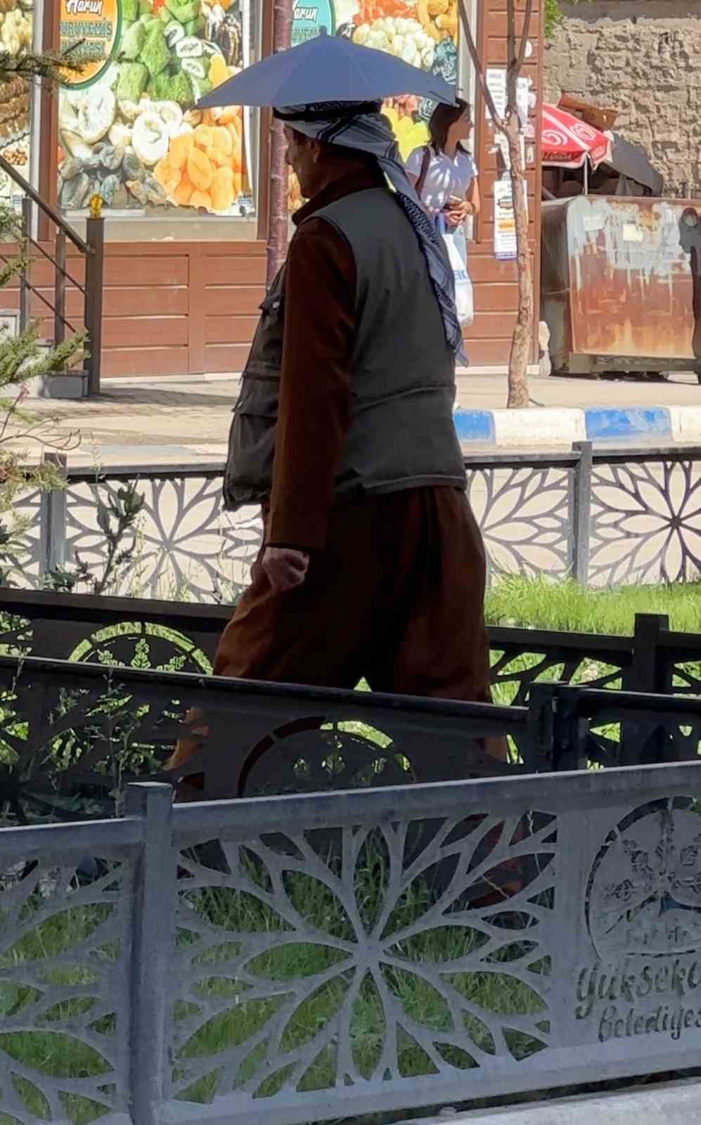 Y&uuml;ksekovalı vatandaş yıllardır kafa şemsiyesiyle g&uuml;neşten korunuyor

