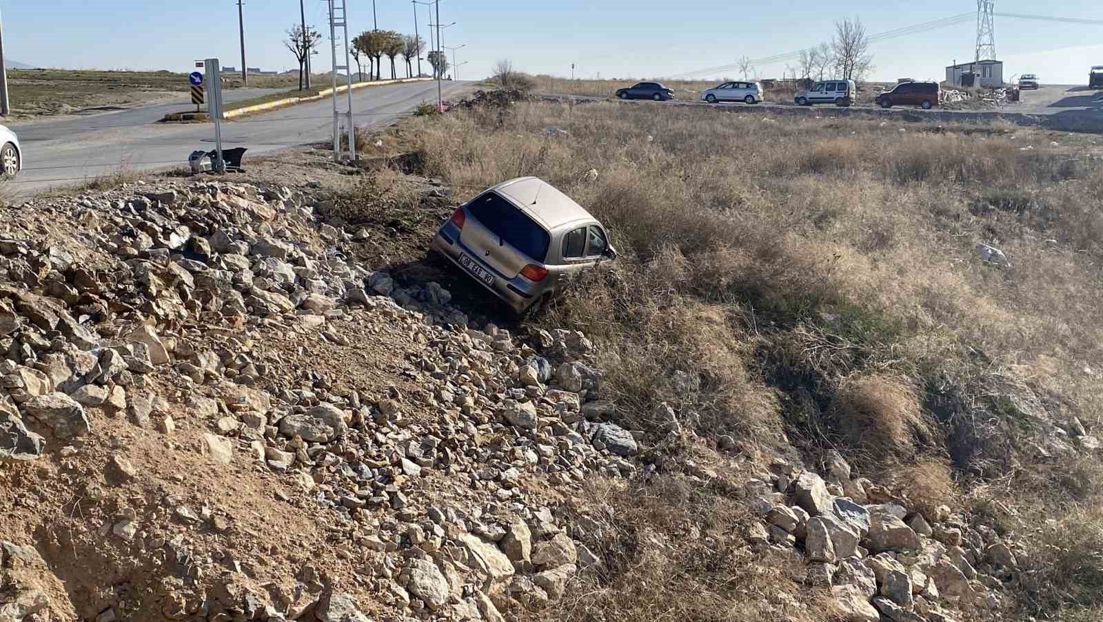 Yoldan çıkan otomobil taşlık alanda asılı kaldı