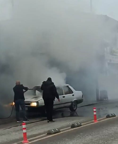Seyir halindeki otomobil yandı, esnaf yardıma koştu
