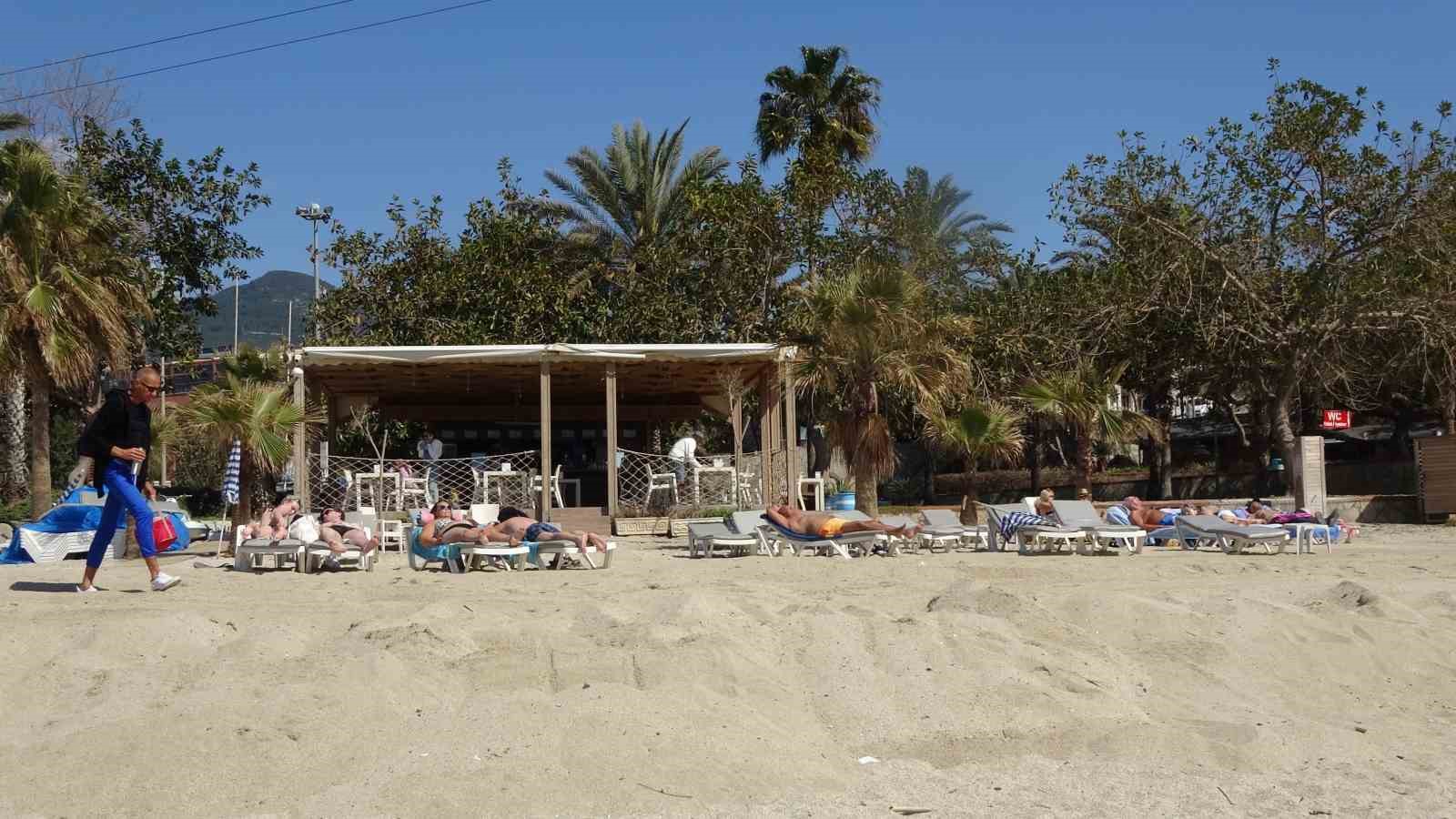 Alanya&rsquo;da mart ayı ortasında yaz g&ouml;r&uuml;nt&uuml;leri: Hava sıcaklığı 20 dereceye &ccedil;ıkınca deniz ve g&uuml;neşin tadını &ccedil;ıkardılar
