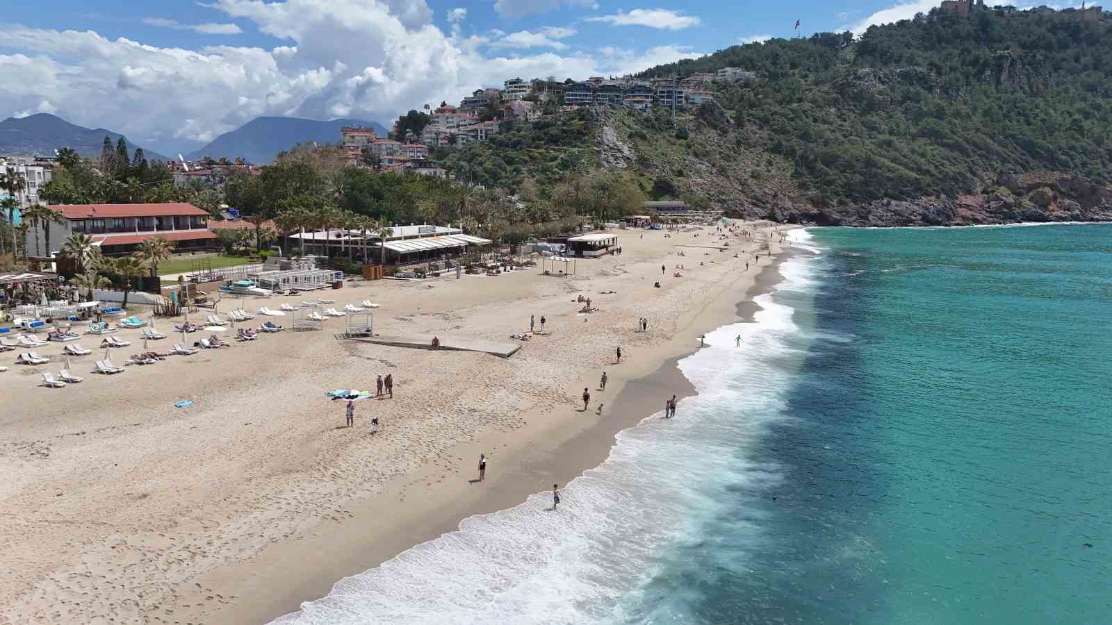 Alanya&rsquo;da erken yaz g&ouml;r&uuml;nt&uuml;leri: 21 dereceyi g&ouml;ren denize koştu
